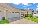Inviting townhome with a two-car garage, and a well-kept lawn at 42 Enclave Dr, Winter Haven, FL 33884