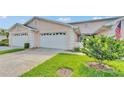 Charming townhome featuring well-manicured lawns and a two-car garage at 42 Enclave Dr, Winter Haven, FL 33884
