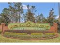 The Highlands Reserve Golf Community sign, surrounded by manicured landscaping and mature trees at 435 Gleneagles Dr, Davenport, FL 33897