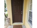 Inviting front door with decorative brick accents and a welcoming mat at 5407 Quarry Rock Rd, Lakeland, FL 33809