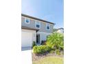 This two-story house features gray siding, a well-maintained lawn, and mature landscaping at 5531 Keaton Springs Dr, Lakeland, FL 33811
