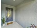 Inviting front porch with a modern door and decorative welcome sign at 6296 Dolostone Dr, Lakeland, FL 33811