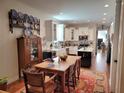 Open kitchen concept with white cabinetry, stainless steel appliances, and an island at 631 W Park St, Lakeland, FL 33803