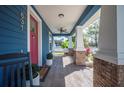 Cozy porch with swing, ceiling fan, and brick columns at 631 W Park St, Lakeland, FL 33803
