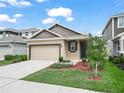 Inviting exterior of home with neat landscaping, lawn, and a two-car garage at 6533 Great Bear Dr, Lakeland, FL 33805