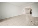 Open living room with tile flooring leading into the dining and kitchen areas at 6533 Great Bear Dr, Lakeland, FL 33805