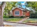 Exterior view of a charming single story home with mature landscaping and brick walkway at 810 Orange Park Ave, Lakeland, FL 33801