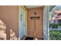 The front porch has a sturdy door to protect the front door, and a convenient broom for keeping the entry neat at 8303 Waterview Way # 8303, Winter Haven, FL 33884