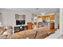 Comfortable living area with wood floors seamlessly connects to the kitchen, creating an inviting open-concept space at 8303 Waterview Way # 8303, Winter Haven, FL 33884
