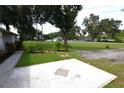 View of concrete patio, lawn, and adjacent home at 1065 Jordan Rd, Lakeland, FL 33811