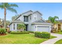 Charming two-story home features a well-manicured lawn, a two-car garage, and a welcoming front porch at 1108 Stoney Creek Blvd, Lakeland, FL 33811