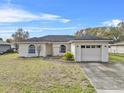 Attractive single-story home with an attached two car garage and charming front yard at 1415 Pinewood Ave, Lakeland, FL 33803