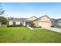 Inviting single-story home with well-kept lawn, two-car garage, and screened front porch at 1888 Creeks Vista Blvd, Lakeland, FL 33810