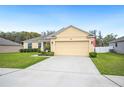 Charming single-story home with a manicured lawn and a two-car garage at 1888 Creeks Vista Blvd, Lakeland, FL 33810