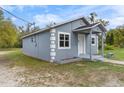 This charming home features a light blue exterior, well-kept lawn, and traditional architectural details at 1925 N Combee Rd, Lakeland, FL 33801