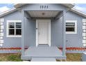 Inviting front entrance with covered porch, showcasing a white door and updated exterior details at 1925 N Combee Rd, Lakeland, FL 33801