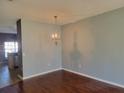 Dining room with hardwood floors features a decorative chandelier and easy access to the kitchen at 2051 Winterset Dr, Lakeland, FL 33813