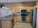 Modern kitchen with stainless steel appliances and granite countertops at 2051 Winterset Dr, Lakeland, FL 33813