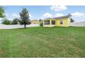 Spacious backyard featuring a large lawn, vinyl fence and a screened in porch at 2170 Country Manor St, Bartow, FL 33830