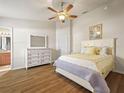 Bright and airy main bedroom showcasing a large dresser and wood-look floors at 2170 Country Manor St, Bartow, FL 33830