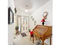 A welcoming foyer with tiled flooring and a decorative secretary desk at 2206 Silver Lakes N Dr, Lakeland, FL 33810