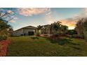 Lush backyard featuring a screened-in pool area, mature landscaping, and privacy fencing at 2726 Greyhawk Estates Ln, Lakeland, FL 33812