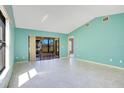 Bright living room with tile flooring, large windows, and sliding door access to the outdoors at 29 Buck Cir, Haines City, FL 33844