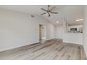 Bright open-concept living area featuring stylish flooring, a ceiling fan, and neutral paint at 3815 Horizon View Loop, Lakeland, FL 33813