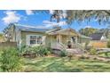 Inviting home showcasing a covered porch with white railing and green lawn at 4620 S Gary Ave, Lakeland, FL 33813