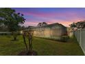 Spacious backyard featuring a screened-in pool and lush green lawn at 4769 Highlands Place Cir, Lakeland, FL 33813