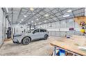 Interior view of a large, well-lit outbuilding with a car parked at 5062 1St Nw St, Lakeland, FL 33810