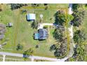 Aerial view of a private estate including pool, outbuildings, and fenced pastures at 5118 Eagles Nest Dr, Lakeland, FL 33810