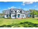 Attractive two-story home with a well-manicured lawn and colorful landscaping at 5118 Eagles Nest Dr, Lakeland, FL 33810