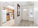 Inviting entryway features tile flooring, a white door, and a partial view of the kitchen at 5225 Imperial Lakes Blvd # 49, Mulberry, FL 33860