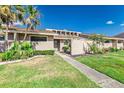 Inviting single story home featuring lush landscaping, a walkway, and a light beige exterior at 5225 Imperial Lakes Blvd # 49, Mulberry, FL 33860