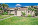 Inviting single story home featuring lush landscaping, a walkway, and a light beige exterior at 5225 Imperial Lakes Blvd # 49, Mulberry, FL 33860