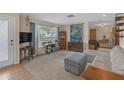 Open-concept living room featuring plush seating, vintage sewing machine, and bright natural light at 531 Gibson S Rd, Lakeland, FL 33813