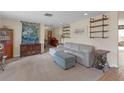 Spacious living room with comfortable seating, vintage sewing machine, and custom shelving at 531 Gibson S Rd, Lakeland, FL 33813