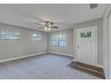 Inviting living room featuring plush carpeting, fresh neutral paint, and a modern ceiling fan at 5420 Ivory Ln, Lakeland, FL 33811