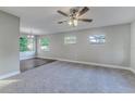 Open-concept living room with large windows, new carpet, and seamlessly connected dining area at 5420 Ivory Ln, Lakeland, FL 33811