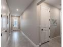 Bright hallway with tile flooring, white doors, and recessed lighting for a modern feel at 5431 Arlington River Dr, Lakeland, FL 33811