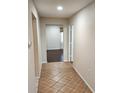 Inviting hallway features tile flooring, leading to a bedroom with hardwood floors at 561 Lake Mystic Ln, Lakeland, FL 33813