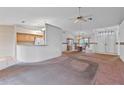 Open-concept living room and dining area with neutral colors and a ceiling fan at 5725 Mallard Dr, Lakeland, FL 33809