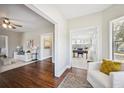 Open-concept view from living room to sunroom with hardwood floors and neutral-toned decor at 624 Woodward St, Lakeland, FL 33803