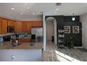 Open kitchen featuring stainless steel appliances, wood cabinets and stone countertops at 6397 Torrington Cir, Lakeland, FL 33811