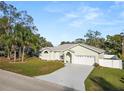 Inviting single-story home with a two-car garage and freshly landscaped front yard at 7211 Scenic Hills Blvd, Lakeland, FL 33810