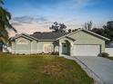 Charming single-story home featuring a well-manicured lawn and attached two-car garage at 7211 Scenic Hills Blvd, Lakeland, FL 33810