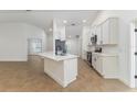 Bright, open kitchen featuring stainless steel appliances, white cabinetry, and a center island at 750 W Vine St, Bartow, FL 33830