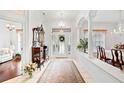 Elegant foyer featuring tile floors, chandelier, and decorative columns at 940 Ashton Oaks Cir, Lakeland, FL 33813