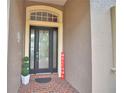 Elegant front entrance with decorative glass door, brick landing, and potted plants at 1 Lake Eloise Ln, Winter Haven, FL 33884